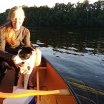 Image of Anne Lictenwalner in a boat with her Dog.